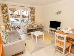 a living room with a couch and a table at Harbour View Poole in Poole