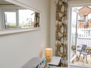 a living room with a window and a view of a balcony at Harbour View Poole in Poole