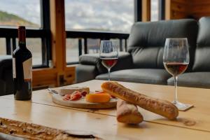 a table with two glasses of wine and a plate of food at Le Tresor du Lac in Mandeville +32 photos