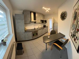 a large kitchen with a table and chairs in a room at Apartment Akazie in Weinsheim +10 photos