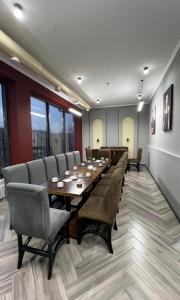 a conference room with a long table and chairs at Van park hotel in Shymkent