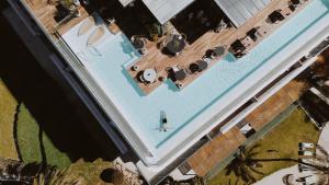 an overhead view of a swimming pool with chaises at Aguas de Ibiza Grand Luxe Hotel - Small Luxury Hotel of the World in Santa Eularia des Riu +84 photos