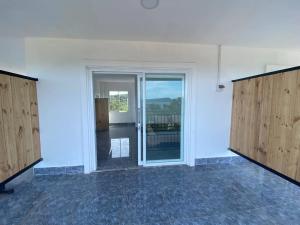 an empty room with sliding glass doors with a view at Big Head Bungalows in Koh Rong Sanloem +31 photos