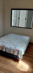 ein Bett in einem Zimmer mit einem Fenster in der Unterkunft Casa de 01 quarto para temporada in Marataizes