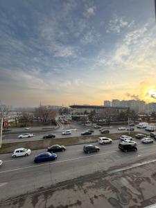a parking lot full of cars on a highway at Home Inn Hotel in Almaty