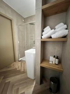 a bathroom with a shower and a sink and towels at Telese Charme B&B in Telese