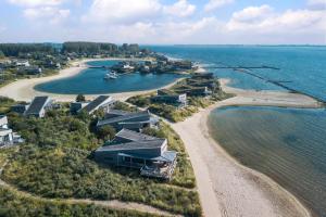 an aerial view of a beach with houses and the water at Beach Resort Punt West in Ouddorp