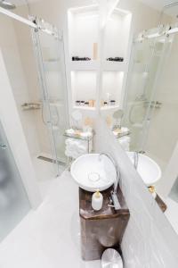 a bathroom with a sink and two mirrors at Casa Matteo Piran in Piran +22 photos