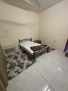 a bedroom with a bed in a room with a rug at AJMAN HOME Stay ONLY FOR COUPLES FAMILY AND LADIES in Ajman 