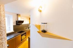a kitchen with white walls and a counter top at Casa Matteo Piran in Piran