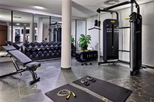 a fitness room with a gym with a treadmill at Four Points by Sheraton Munich Messe in Munich