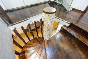 a spiral staircase in a church with a table and chairs at Casa Matteo Piran in Piran