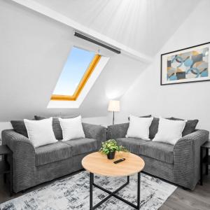 a living room with two couches and a table at Modern Apartment - Accommodates 4 - On Street Parking - Neftlix 2CR in Birmingham