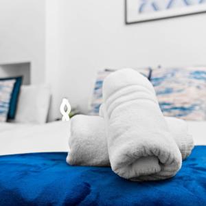 a stuffed animal is laying on a bed at Modern Apartment - Accommodates 4 - On Street Parking - Neftlix 2CR in Birmingham