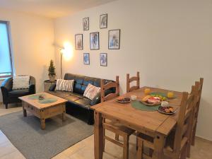 a living room with a table and a couch at Pine`s Lodge , private WiFi, free Parking in Bansko