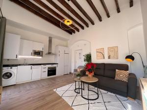 a living room with a couch and a table at Life Apartments Arcos 27 in Jerez de la Frontera