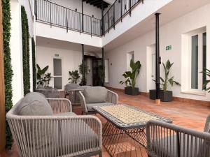 a patio with chairs and tables and plants at Life Apartments Arcos 27 in Jerez de la Frontera
