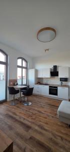 a kitchen with a table and chairs in a room at FewoNr9 in Magdeburg