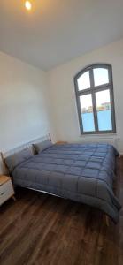 a large bed in a room with a window at FewoNr9 in Magdeburg