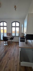 an empty room with a kitchen with two windows at FewoNr9 in Magdeburg
