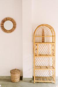 a bamboo shelf in a room with a mirror at Naïa Ocean House Midigama in Midigama West