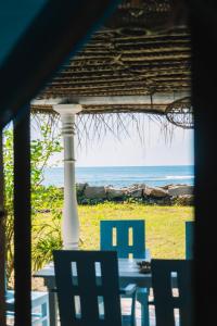 a table and chairs with a view of the ocean at Naïa Ocean House Midigama in Midigama West