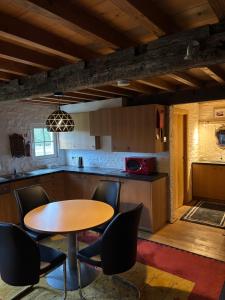 a kitchen with a wooden table and chairs at Hamiora wellness B&B in Deinze