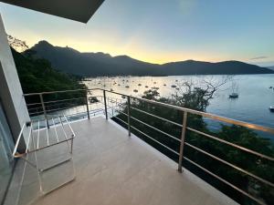 a balcony with a view of a body of water at Asalem in Abraão