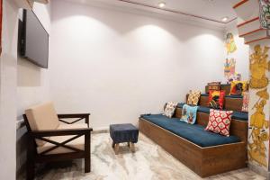 a living room with a couch and a chair at Stamps By Eight Continents, Pushkar in Pushkar