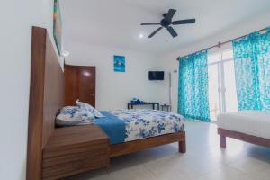 a bedroom with a bed and a ceiling fan at Departamentos Blue Bacalar in Bacalar