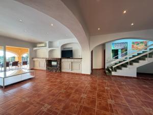 an empty living room with a staircase in a house at Ses Casetes Abajo in San Jose