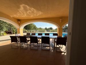 a patio with a table and chairs and a swimming pool at Ses Casetes Abajo in San Jose