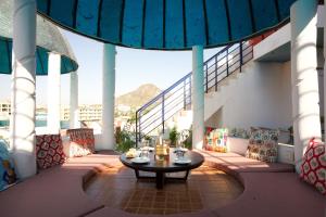 a patio with a table on a balcony at Stamps By Eight Continents, Pushkar in Pushkar
