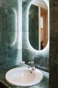 a bathroom with a sink and a mirror at Evi Suite in Santa Margherita Ligure +9 photos