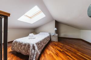 a bedroom with a bed and a skylight at Evi Suite in Santa Margherita Ligure