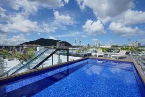 a swimming pool on the roof of a building at La Cuadra - Casco Viejo in Panama City