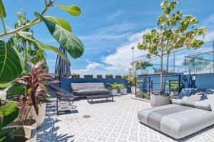 a patio with furniture and plants on a roof at La Cuadra - Casco Viejo in Panama City