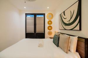 a bedroom with a large white bed with pillows at La Cuadra - Casco Viejo in Panama City +31 photos