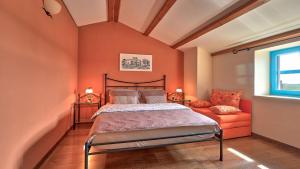 a bedroom with orange walls and a bed and a window at Rustic Villa Simone with outdoor pool in Porec in Krmenjak +27 photos