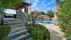 a set of stairs leading up to a house with a swimming pool at Rustic Villa Simone with outdoor pool in Porec in Krmenjak