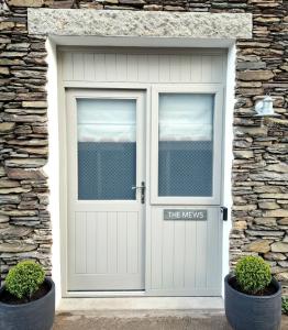 een garagedeur met een bordje waarop staat: de wegen bij The Mews Room at The Coach House in Windermere