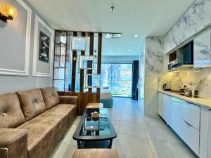 a living room with a couch and a table at Mulberry Homes Supernova in Noida