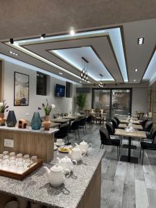 a restaurant with tables and chairs and china at Afsona in Qarshi