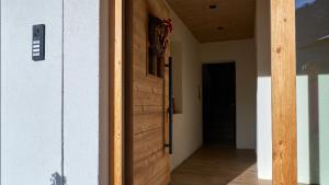 a wooden door in a room with a hallway at Sappada Family Apartments in Sappada