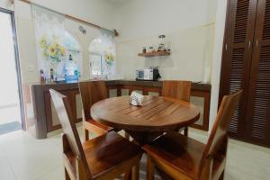 a wooden table and chairs in a kitchen at Departamentos Blue Bacalar in Bacalar +12 photos