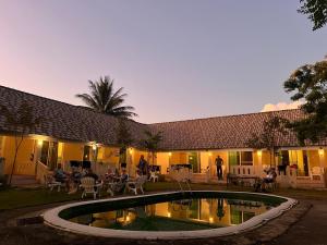 a resort with a pool in front of a building at Baan Kub Doi Mae Chaem in Mae Chaem