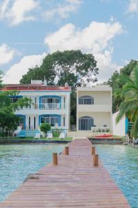 a house on the water with a dock at Departamentos Blue Bacalar in Bacalar