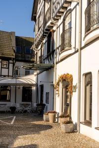 a building with potted plants on the side of it at Hotel Rejs in Ustka
