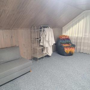 a room with a couch and a rack of clothes at GORY & TYSHA Гори і Тиша in Yavoriv