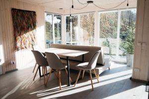 a dining room with a table and chairs and a couch at GORY & TYSHA Гори і Тиша in Yavoriv +4 photos